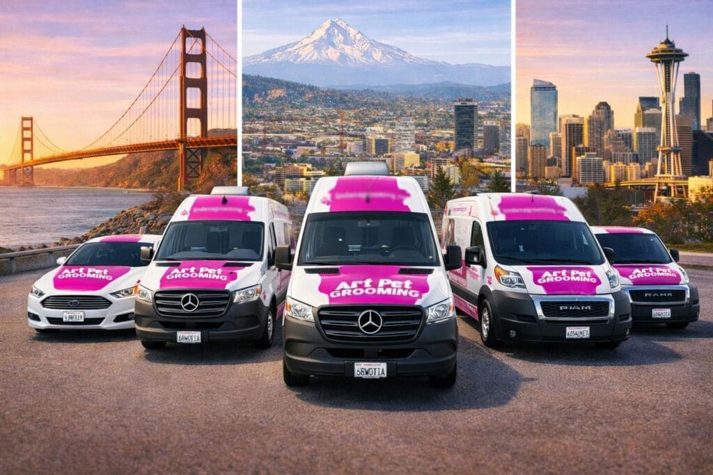 Five Art Pet Grooming vans are parked, ready for mobile pet grooming; city skylines and mountains provide a scenic background.